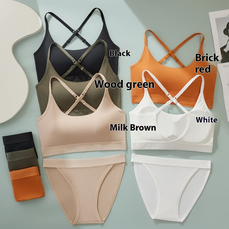 Six wireless bra and panty colorways arranged on a pale blue background, with text labels naming the shades: Black, Brick red, Wood green, White, Milk Brown, and White. A small stack of folded garments appears on the left.