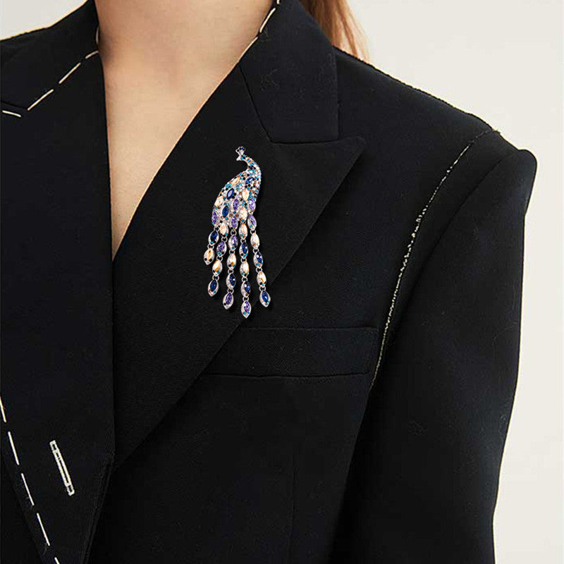 Black blazer with a decorative brooch on a neutral background