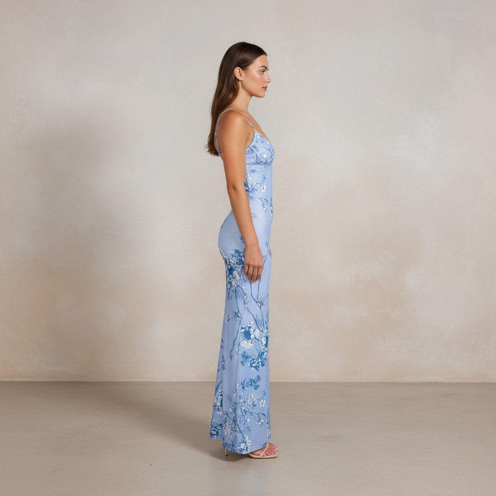 Woman wearing a light blue floral dress on a white background