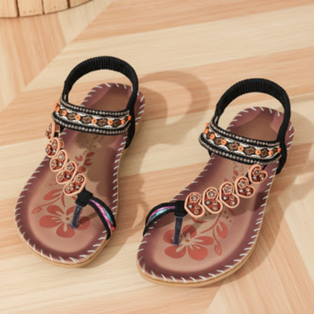 Pair of decorative sandals on a wooden surface