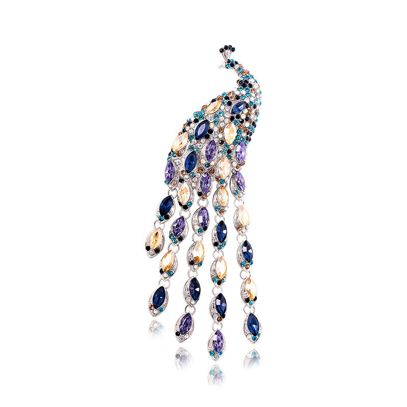 Elegant brooch with blue gemstones on a white background