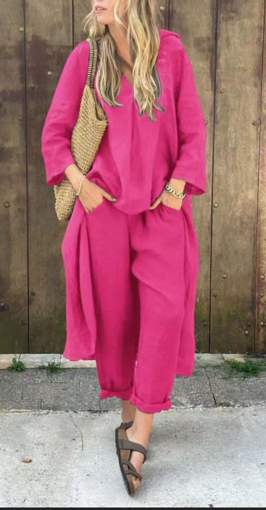 Person wearing a bright pink outfit with a wooden background