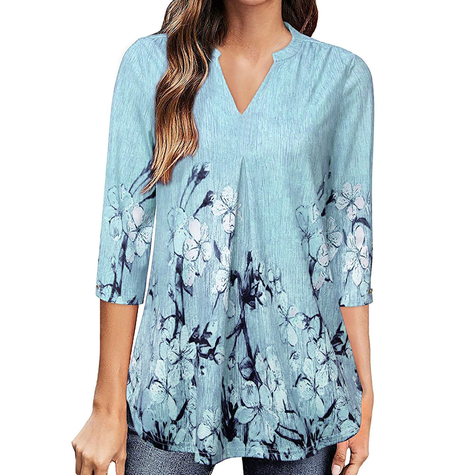 Light blue blouse with floral pattern worn by a person on a white background