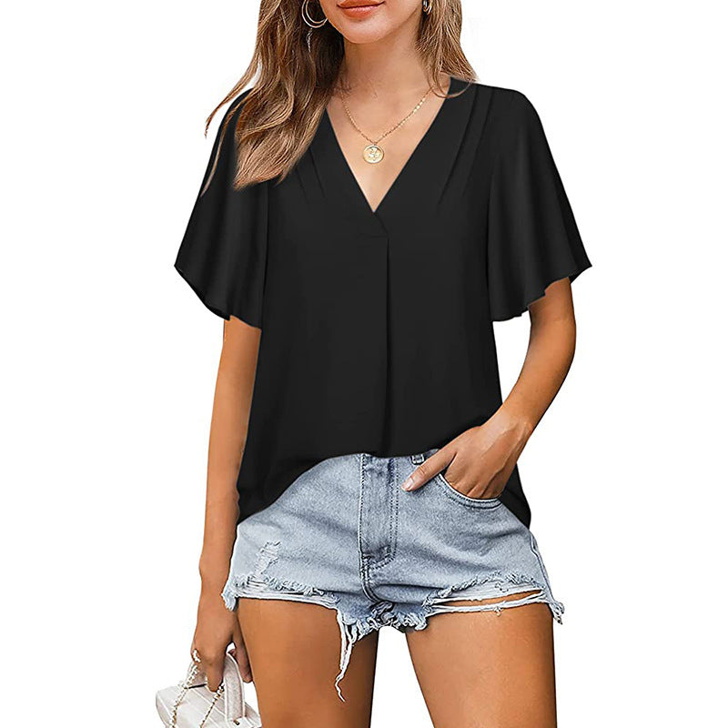 Woman wearing a black top and denim shorts on a white background