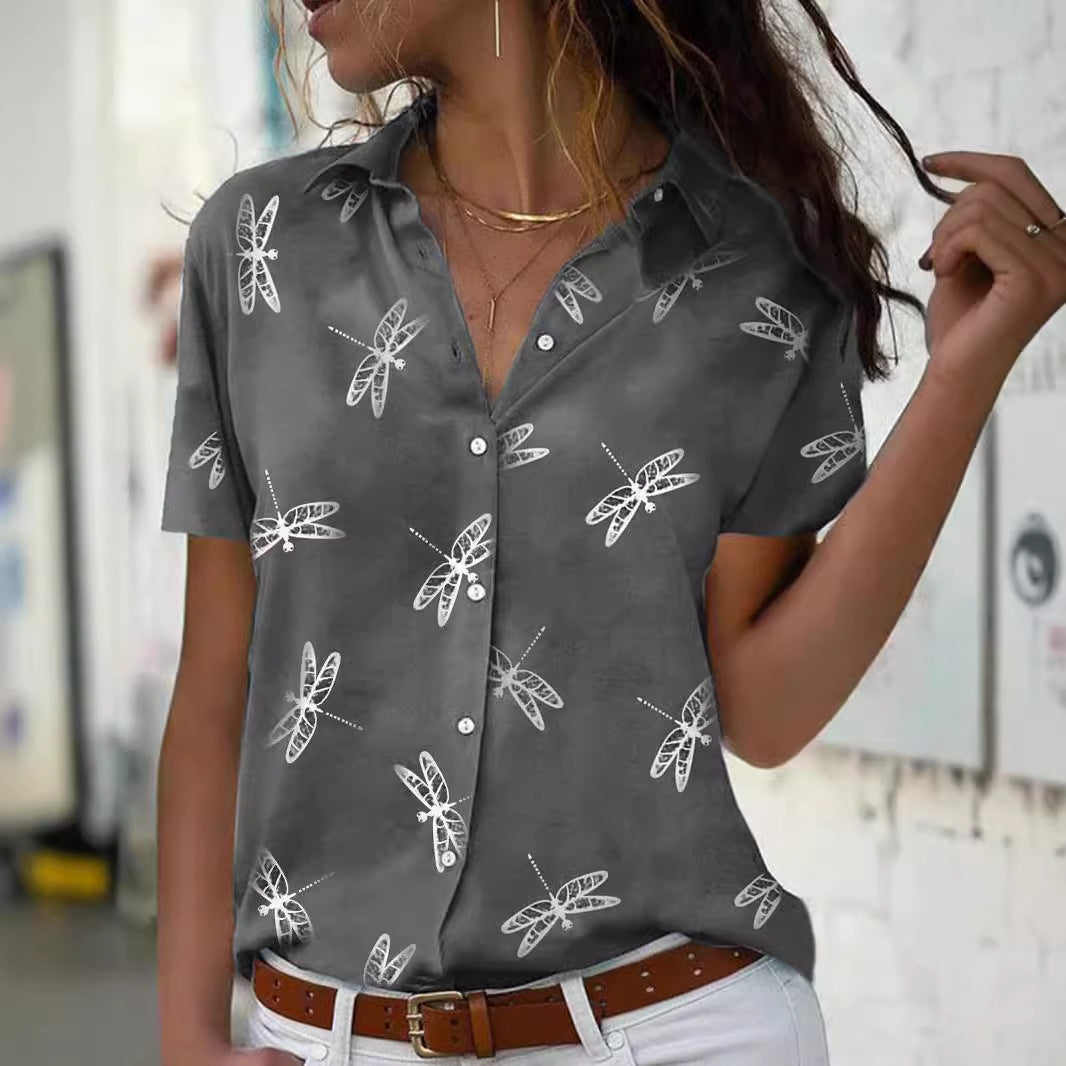 Woman wearing a gray shirt with white insect patterns in an indoor setting