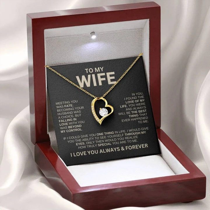 Gold necklace with heart design in a wooden box with a sentimental message card for 'Wife'.