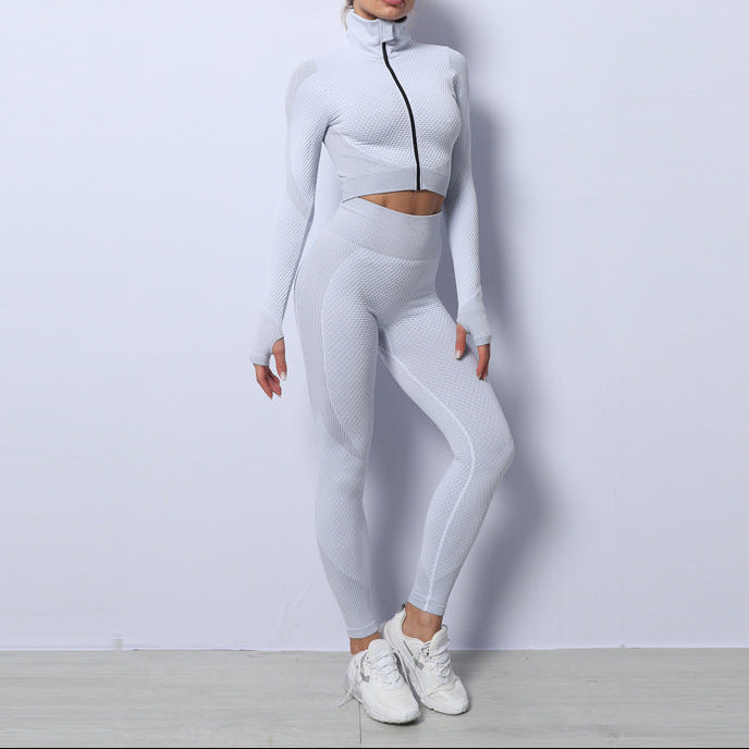 Woman wearing a white athletic outfit against a light gray background