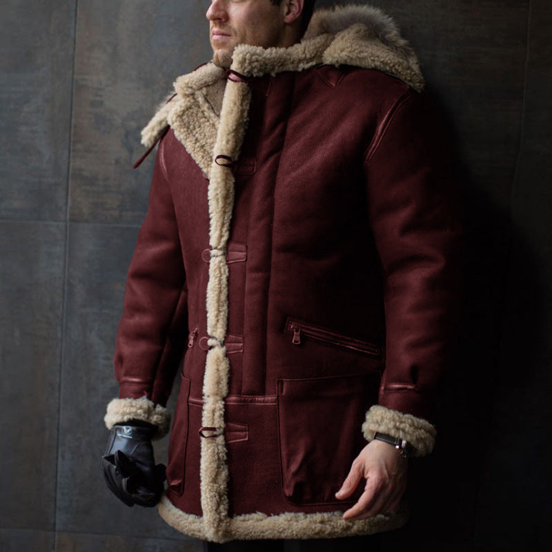 Man wearing a maroon coat with fur trim against a dark background