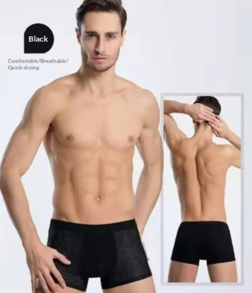 Man wearing black boxer briefs with a focus on comfort and breathability.