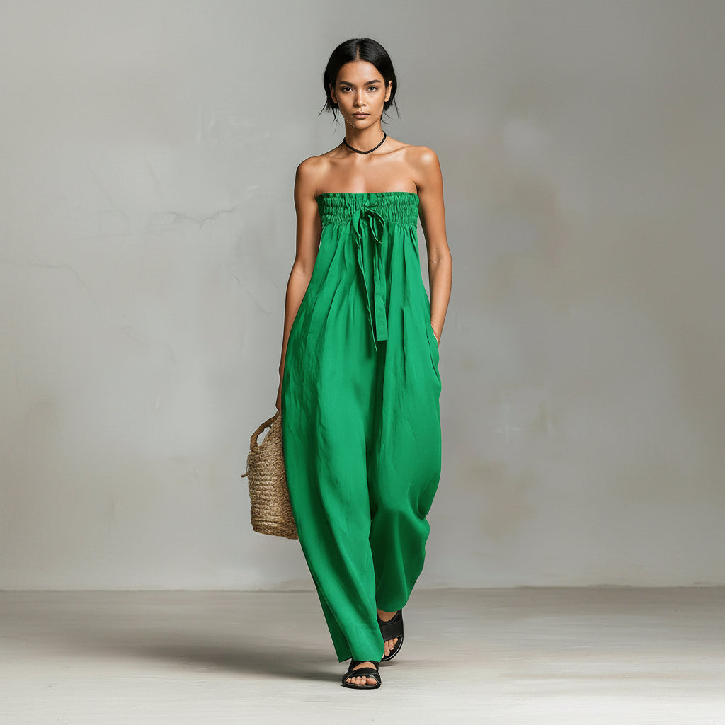 Green strapless dress worn by a person against a neutral background