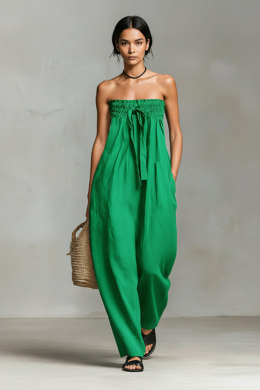 Green strapless dress worn by a person against a neutral background