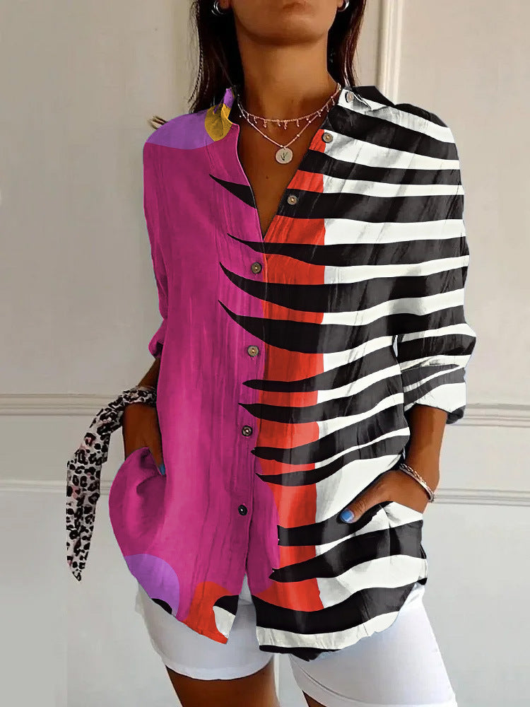 Person wearing a colorful shirt with a mix of pink, black, and white patterns.