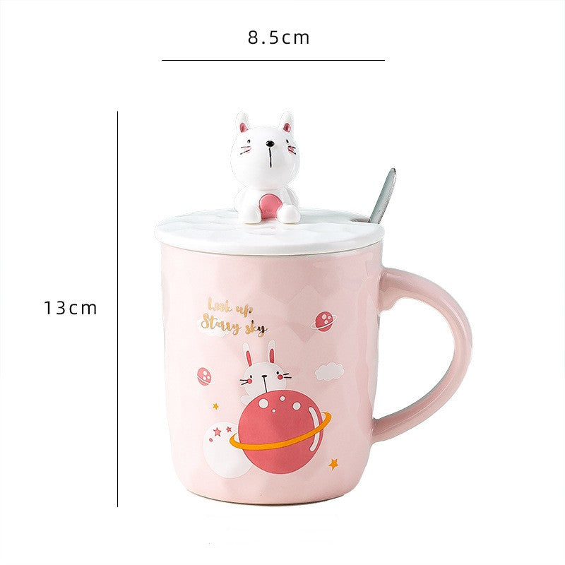 Pink mug with cartoon cat design and measurements on a white background