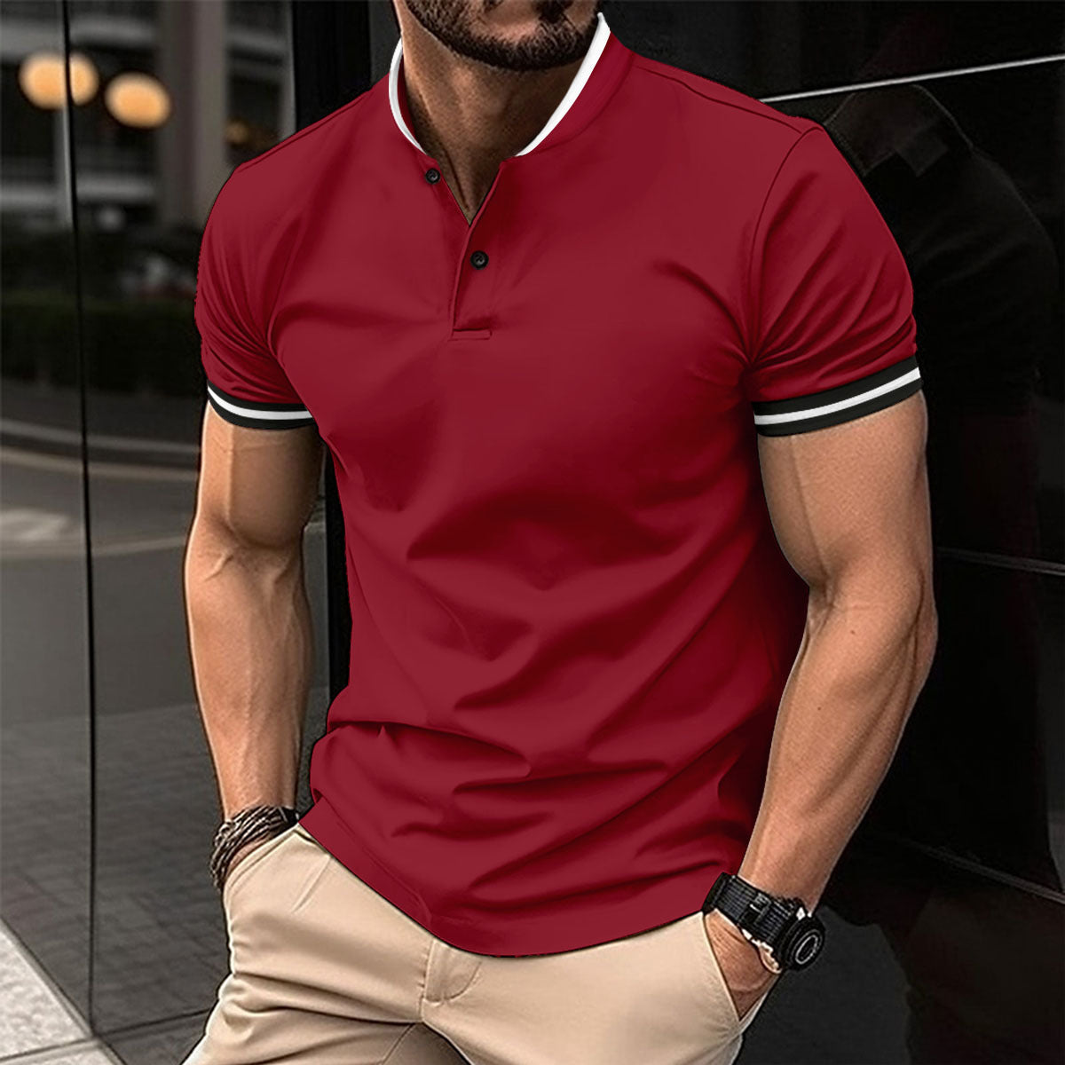 Man wearing a red polo shirt with white trim, standing in front of a car.