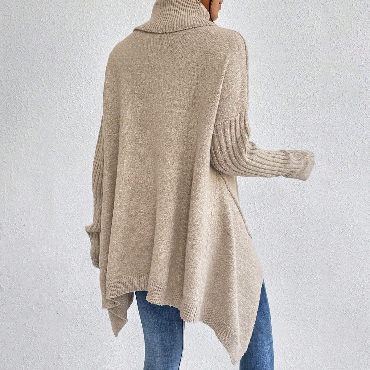 Beige sweater worn by a person on a white background