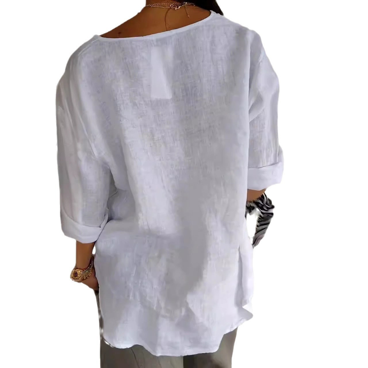 White linen shirt worn by a person on a white background