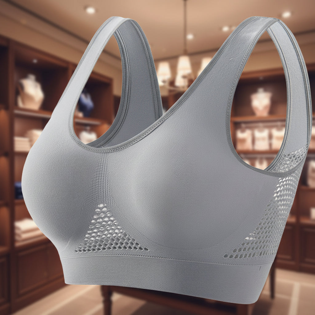Gray sports bra with mesh accents on a white background