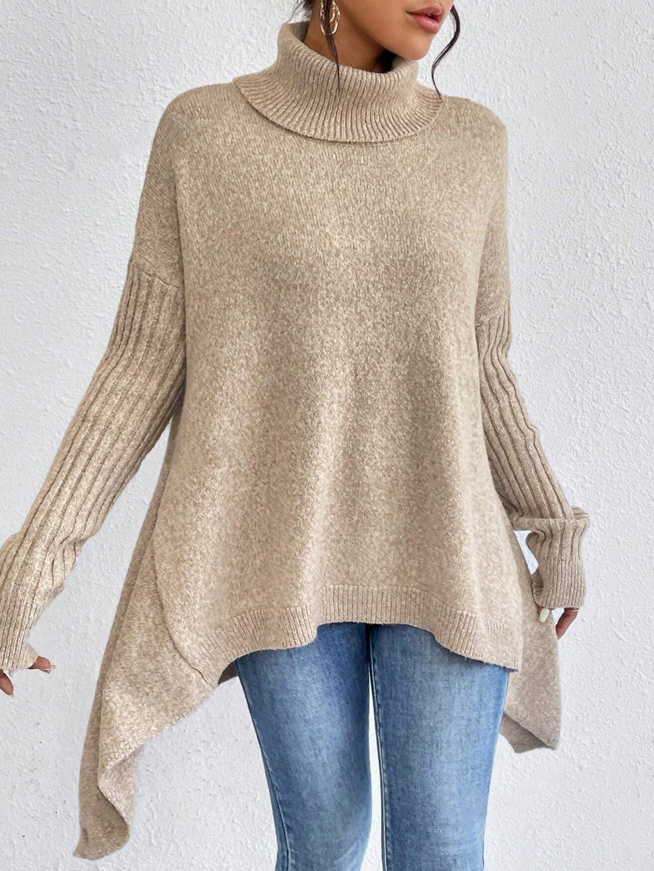 Beige sweater worn by a person on a white background